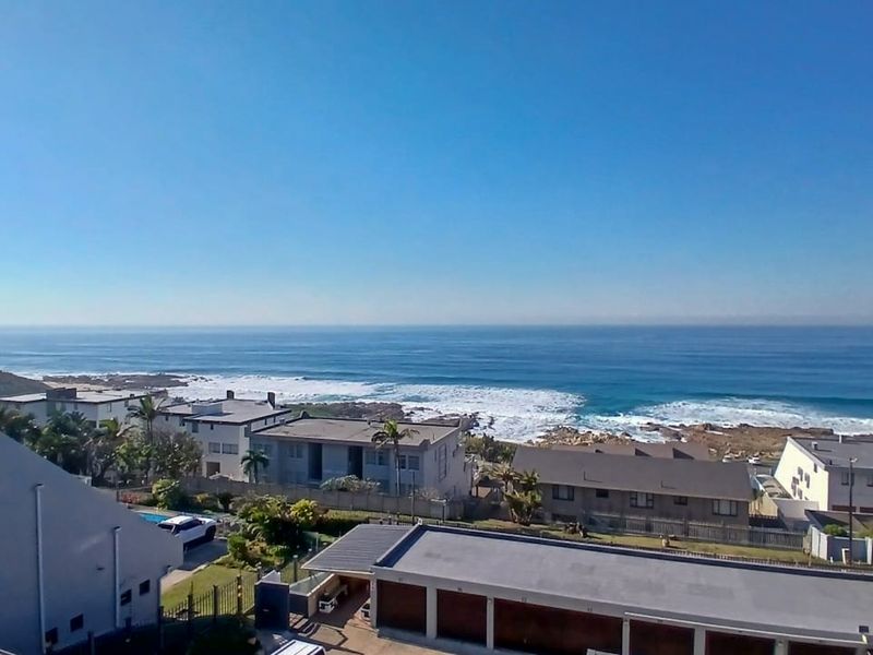 A clear, elevated view overlooking the coastline and ocean, showcasing the property's prime coastal location and surrounding neighborhood.
