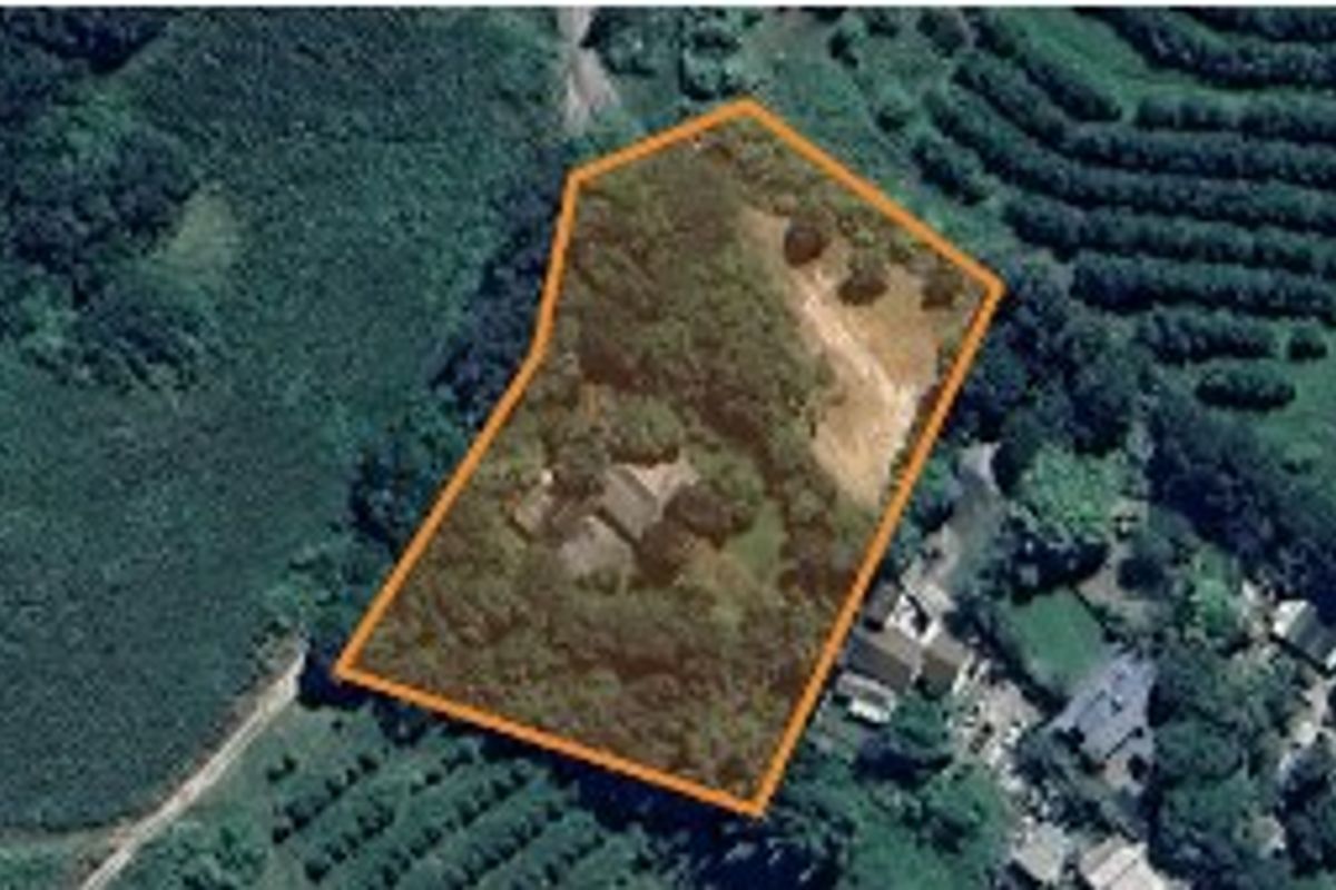 An aerial view of the property showing the land boundary and surrounding landscape.