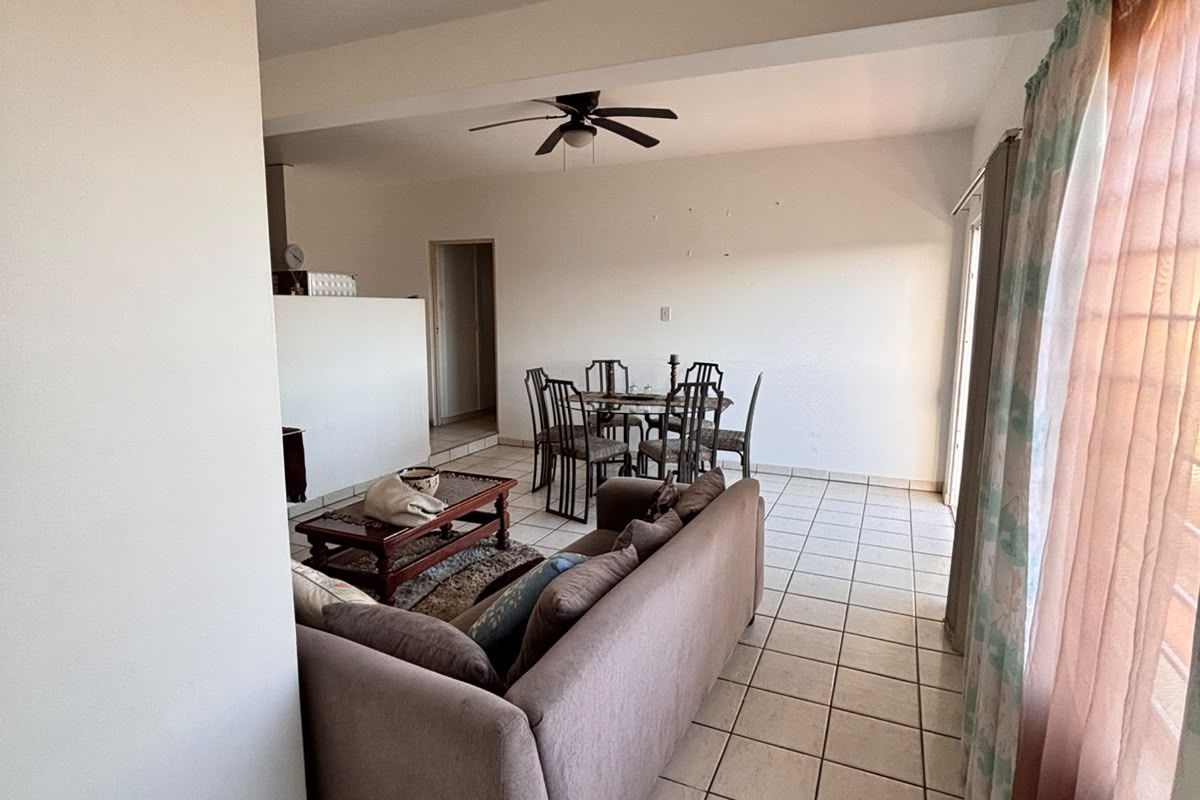 Open plan living and dining area featuring tiled flooring and a ceiling fan, providing a functional layout for daily living.