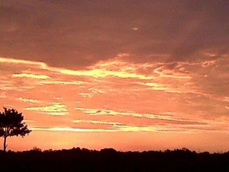 A scenic view of the horizon at sunset over the vacant residential land.