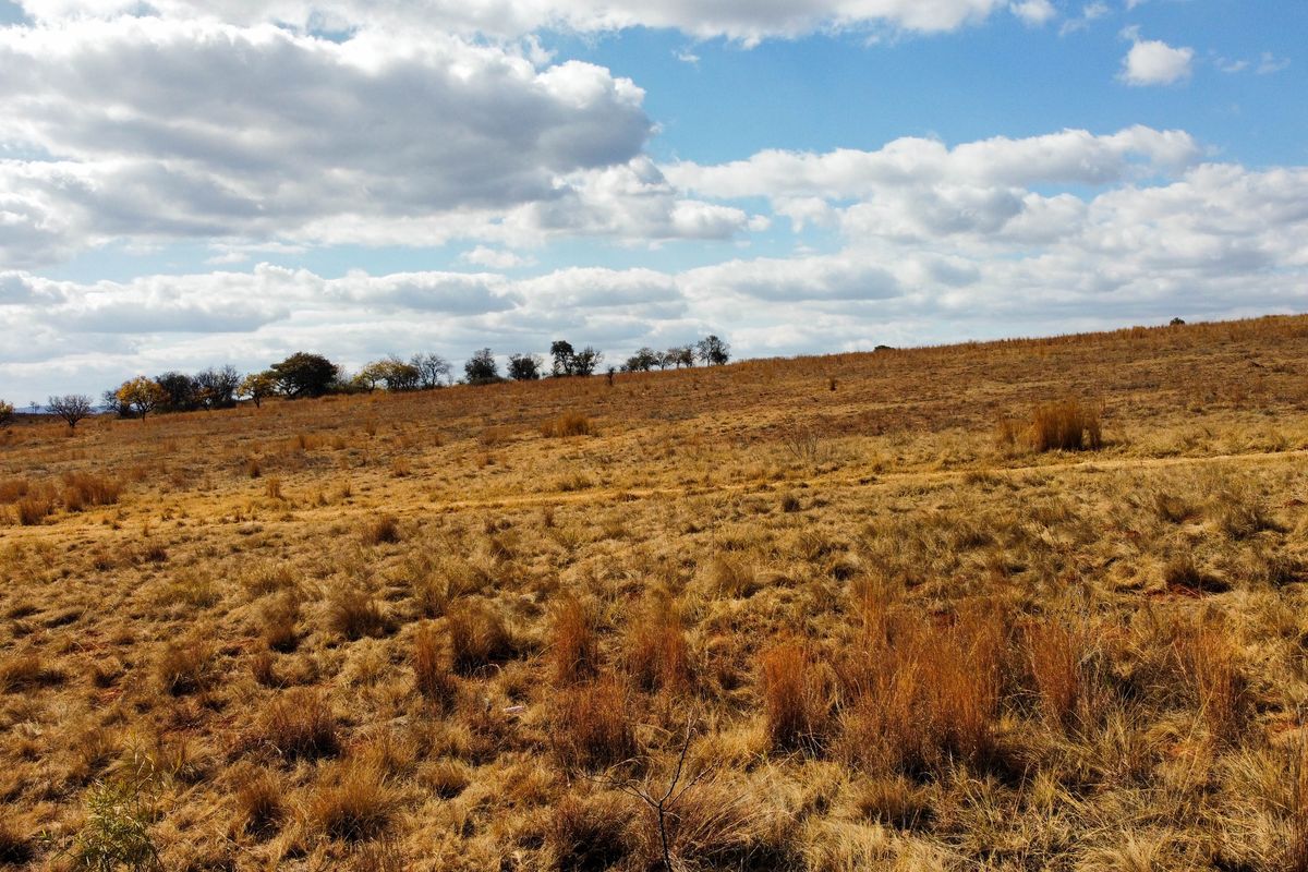 A wide-angle view of the vacant residential land, showcasing the natural topography and open landscape of the property.