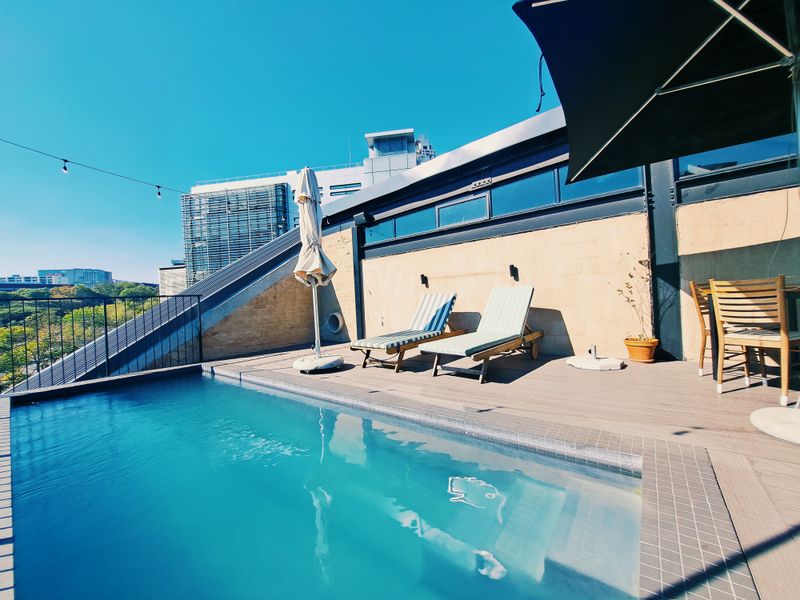 A rooftop terrace featuring a private swimming pool with decking and modern architectural finishes, offering an elevated outdoor living space.