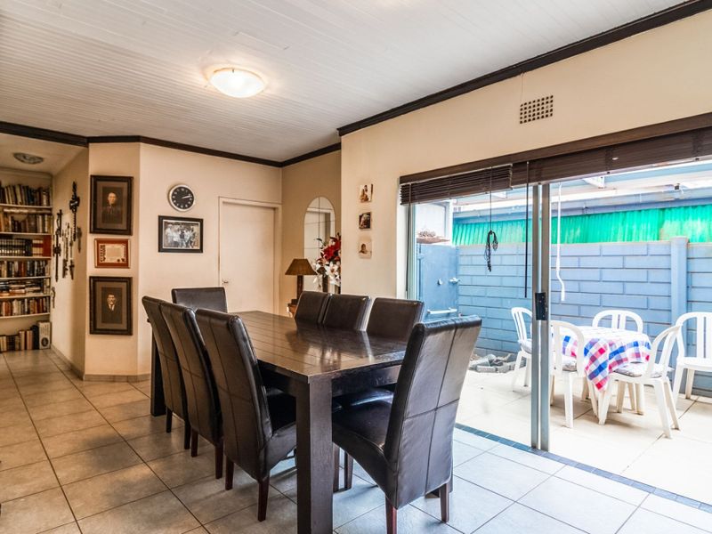 Dining room featuring tiled flooring and a sliding glass door providing direct access to the outdoor patio area.