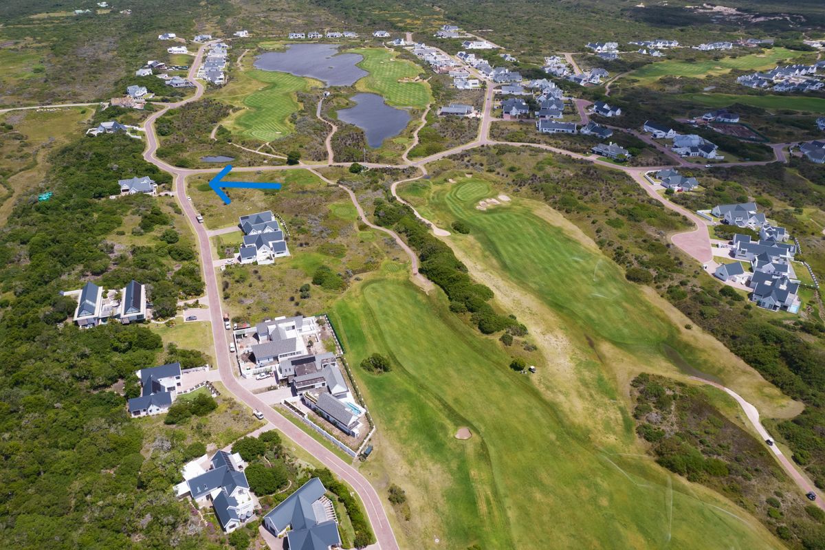 Aerial view of a residential estate plot situated adjacent to a golf course fairway and natural landscape.