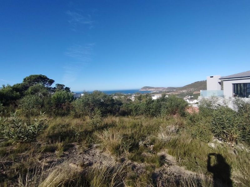 A scenic view overlooking the coastal landscape and surrounding residential area from the vacant residential plot.