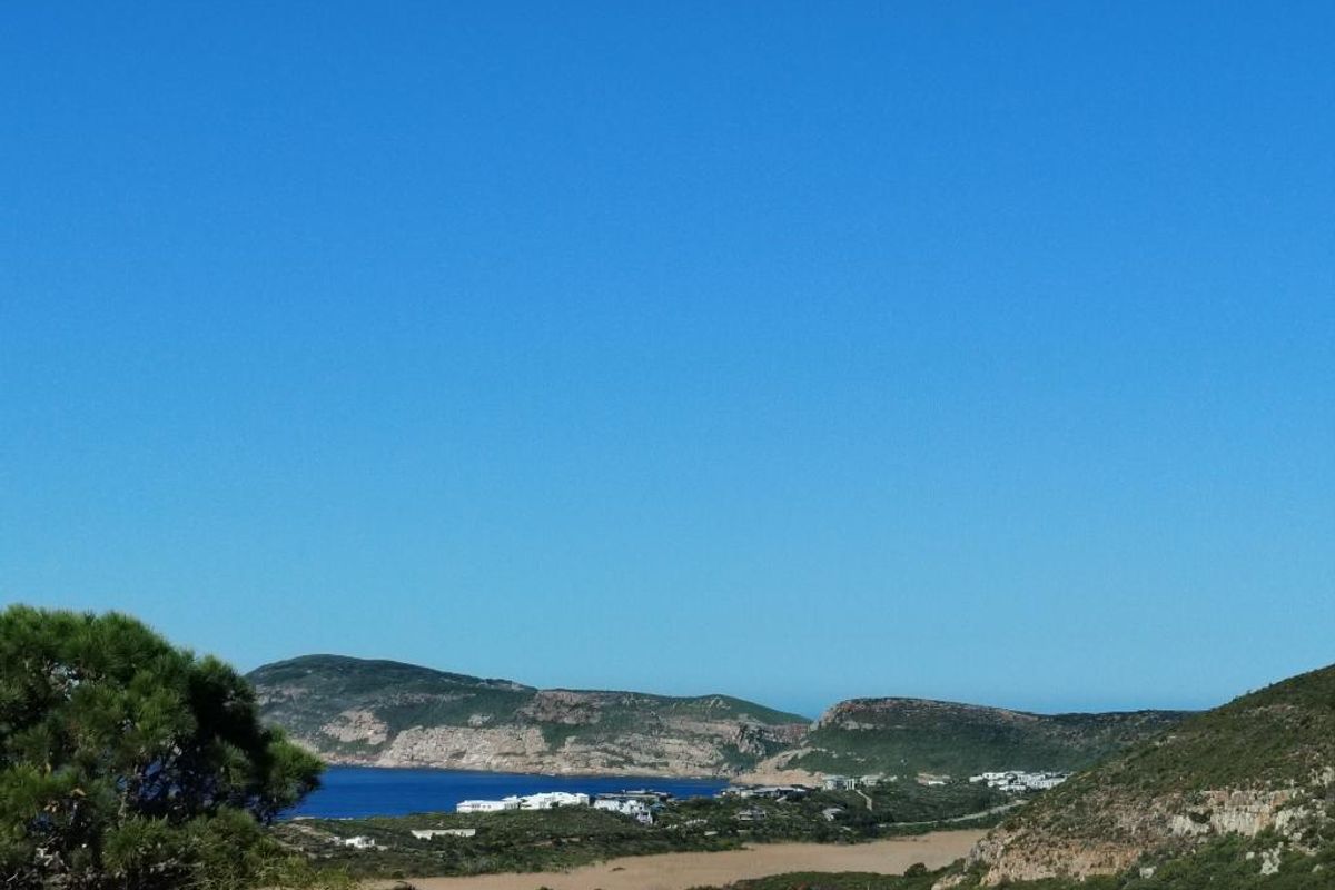 A scenic landscape view overlooking the coastline, hills, and surrounding natural terrain.