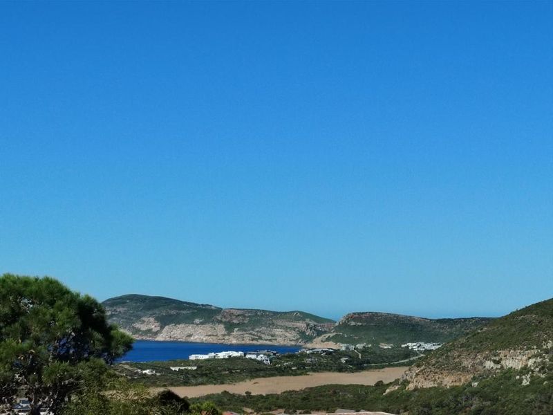 A scenic landscape view overlooking the coastline, hills, and surrounding natural terrain.