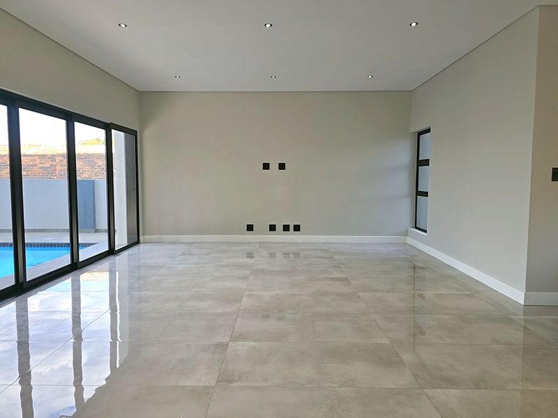 Modern 4-Bedroom, 3 Garage Home with Staff Room and Pool - Photo 10