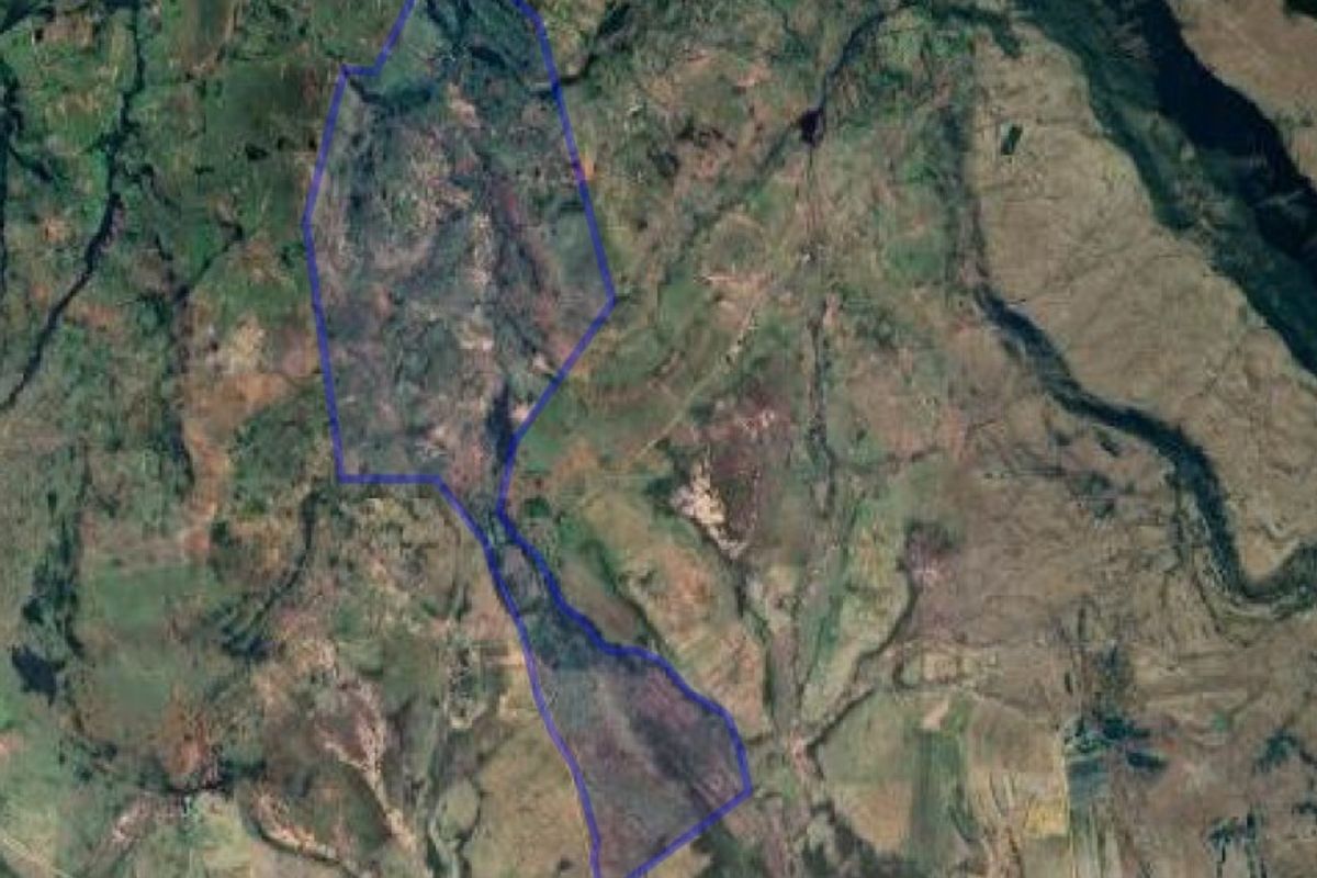 An aerial satellite view showing the boundary outline of the farm property within the surrounding landscape.