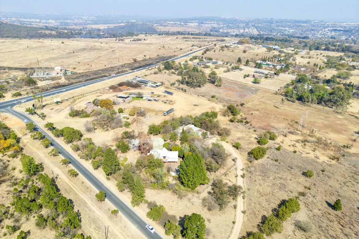 An aerial view of the small holding property, showcasing the surrounding landscape, access roads, and existing vegetation.
