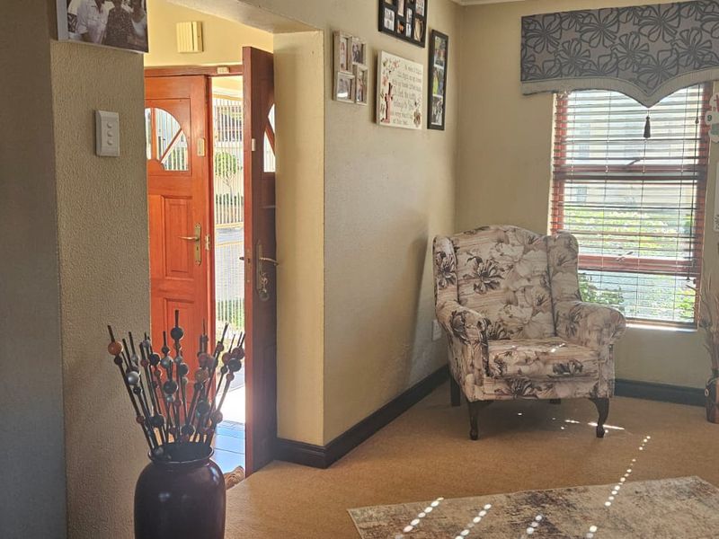 Entrance area featuring a timber front door and window blinds, providing a welcoming transition into the home.