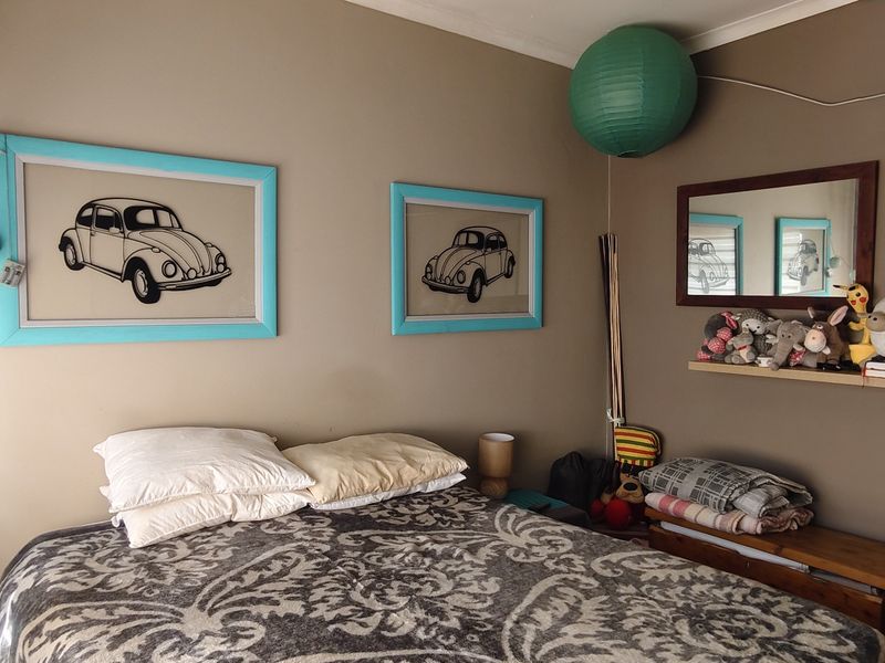 A standard bedroom featuring neutral wall tones and a functional layout, suitable for personalization or modern updates.