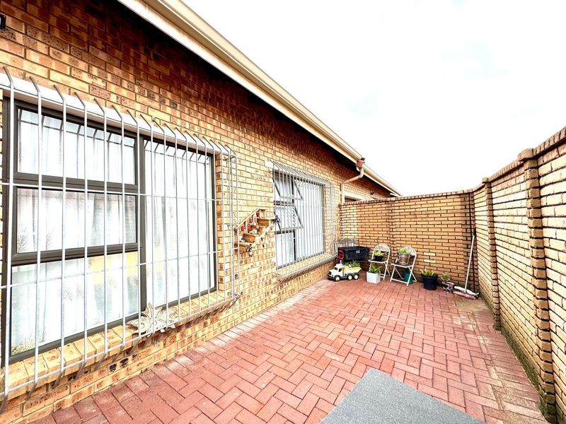 A private rear courtyard featuring brick paving and a high brick boundary wall, providing a secure and low-maintenance outdoor space.