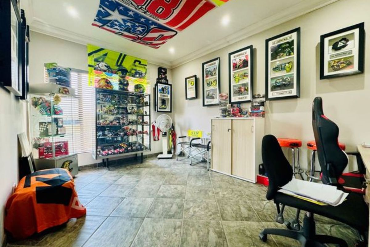 A versatile room featuring tiled flooring and recessed ceiling lighting, currently utilized as a hobby or display space.