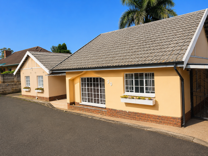 Front elevation of a well-maintained single-story house featuring a tiled roof, brick base detailing, and secure window bars.