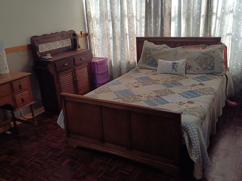 A bedroom featuring traditional parquet flooring and a ceiling vent, offering a classic foundation for potential interior updates.