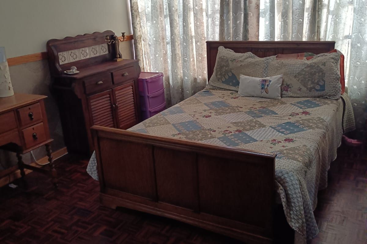 A bedroom featuring traditional parquet flooring and a ceiling vent, offering a classic foundation for potential interior updates.