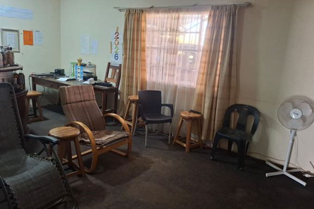 A living area featuring a window with curtains and carpeted flooring, suitable for renovation or restyling to modernize the space.
