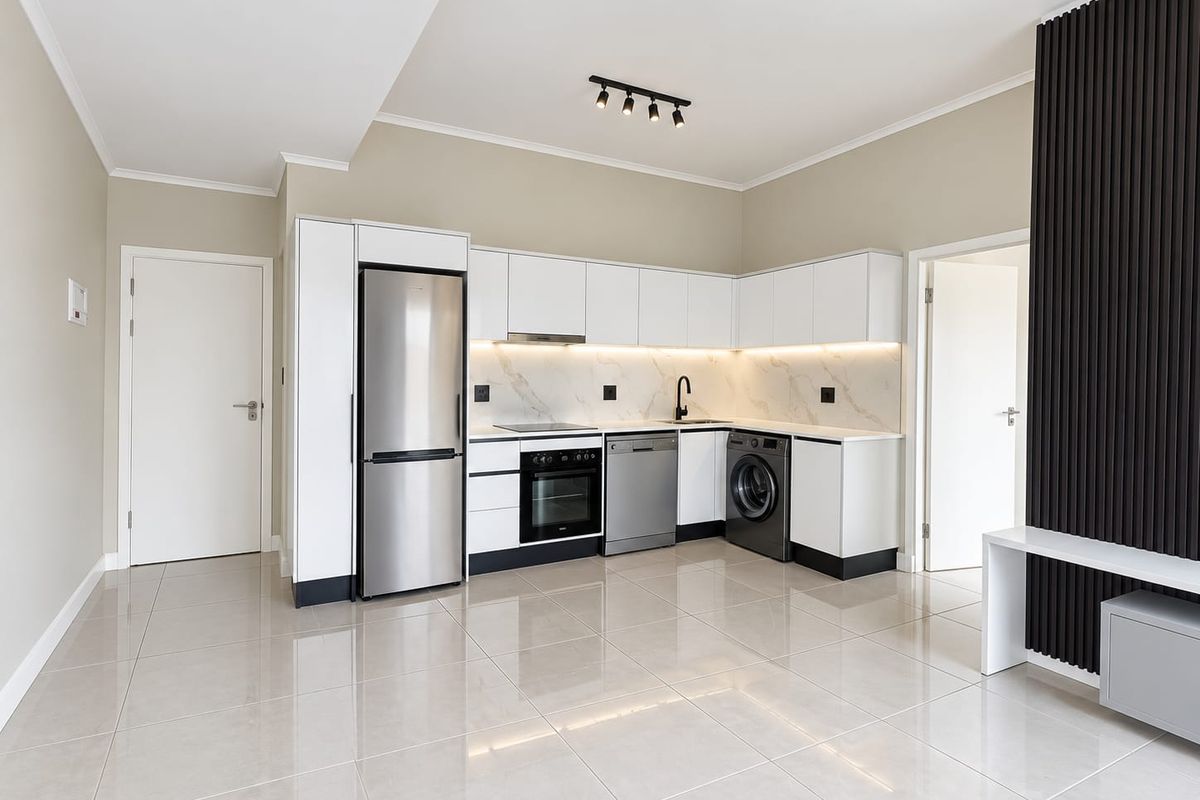 Modern, well-appointed kitchen featuring sleek white cabinetry, marble-look splashback, integrated appliances, and polished tile flooring in an open-plan layout.