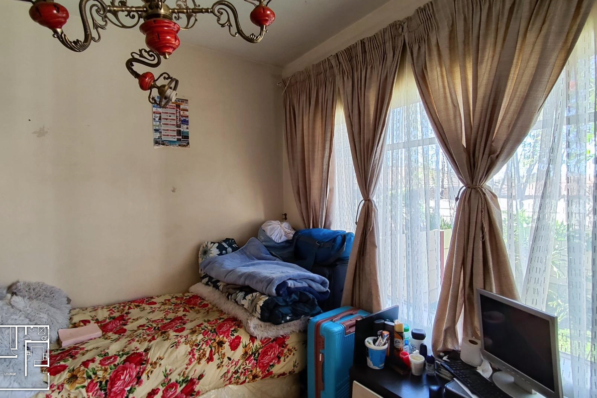 A bedroom featuring a large window with curtains and an ornate chandelier, requiring cosmetic updates to the wall finishes.