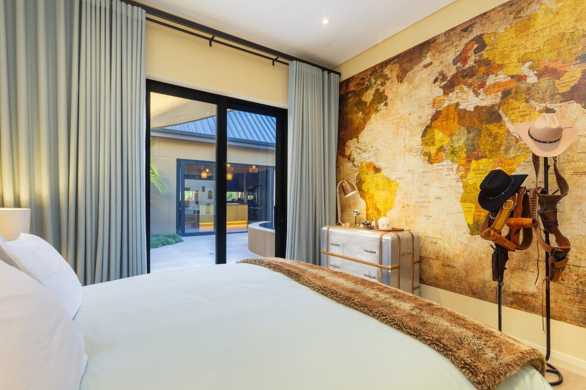 A well-appointed bedroom featuring large sliding glass doors that open onto a private patio area, creating a seamless indoor-outdoor flow.