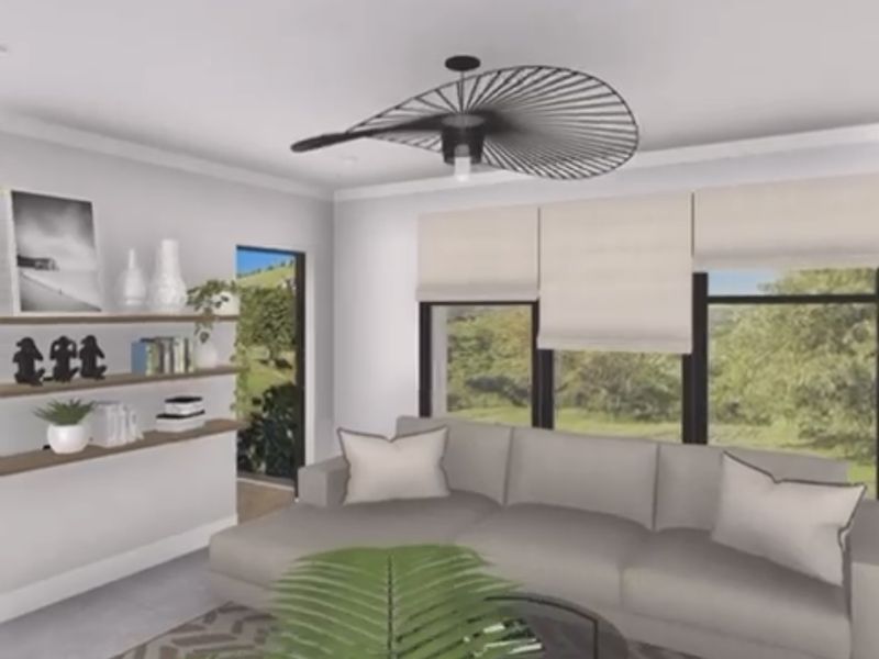 A bright living room featuring large windows with natural views, built-in shelving, and a modern ceiling light fixture.