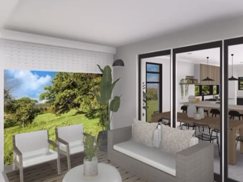 Modern open-plan living area featuring large sliding glass doors that provide seamless indoor-outdoor flow and views of the surrounding landscape.