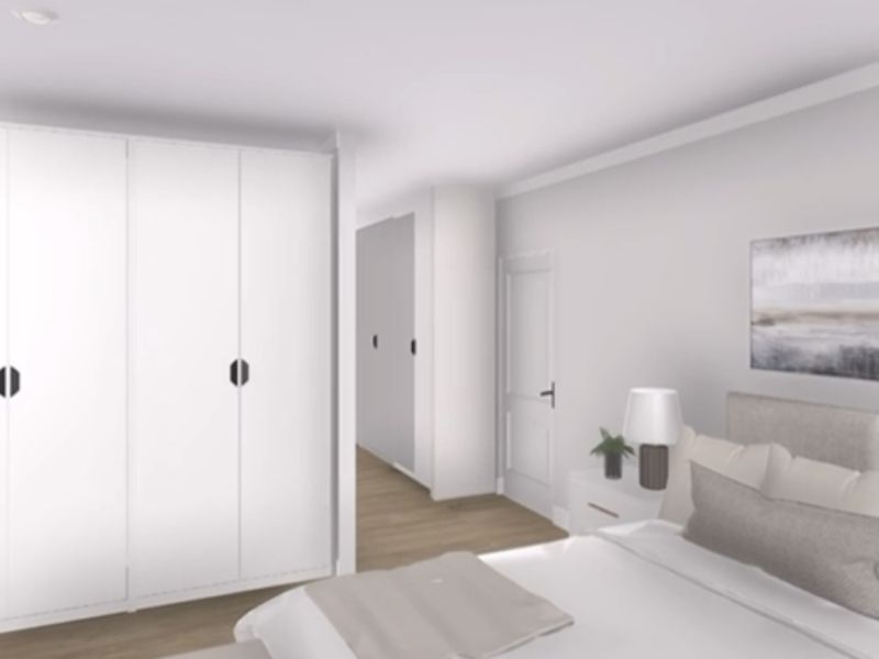 A modern bedroom featuring built-in wardrobes, light hardwood flooring, and neutral finishes, presented as a digital rendering.