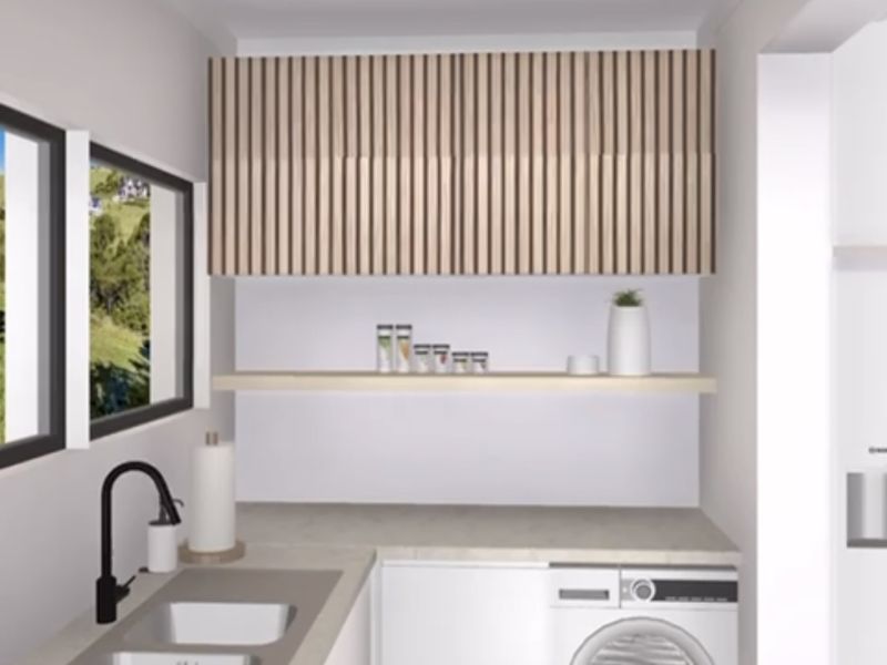 A modern, well-appointed laundry room featuring sleek timber-look cabinetry, stone countertops, an undermount sink with a matte black mixer tap, and integrated laundry appliances.
