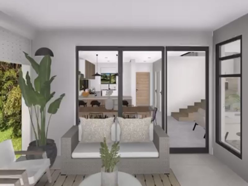 A covered patio area featuring large sliding glass doors that provide a view into the interior living space.