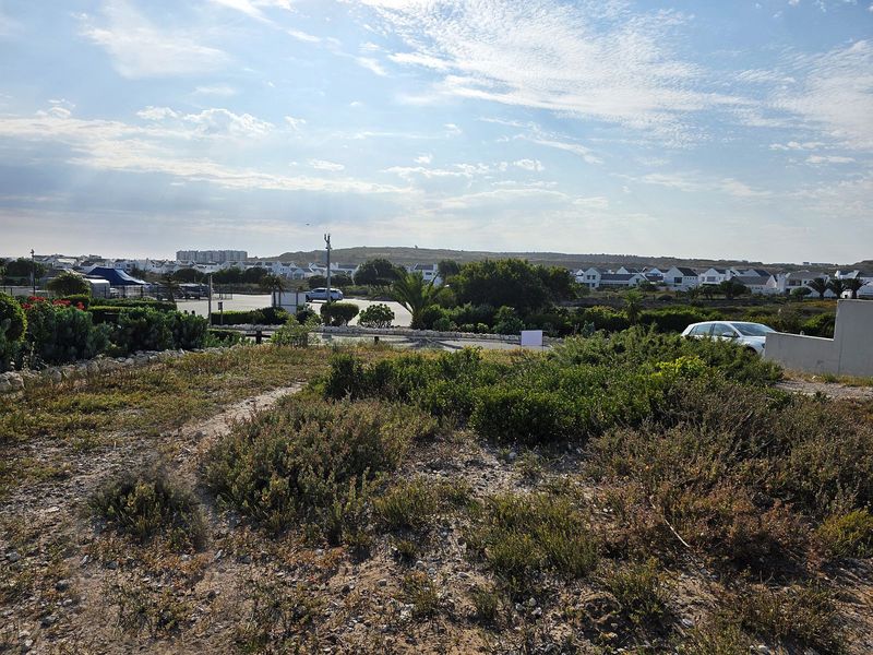 A scenic view overlooking the residential estate and surrounding coastal landscape from the vacant residential plot.