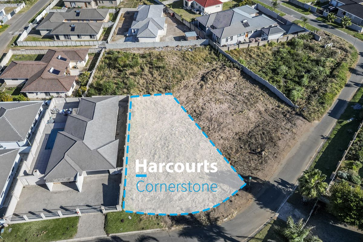 Aerial view of a vacant residential plot in a developed neighborhood, showing clear boundaries and surrounding residential properties.