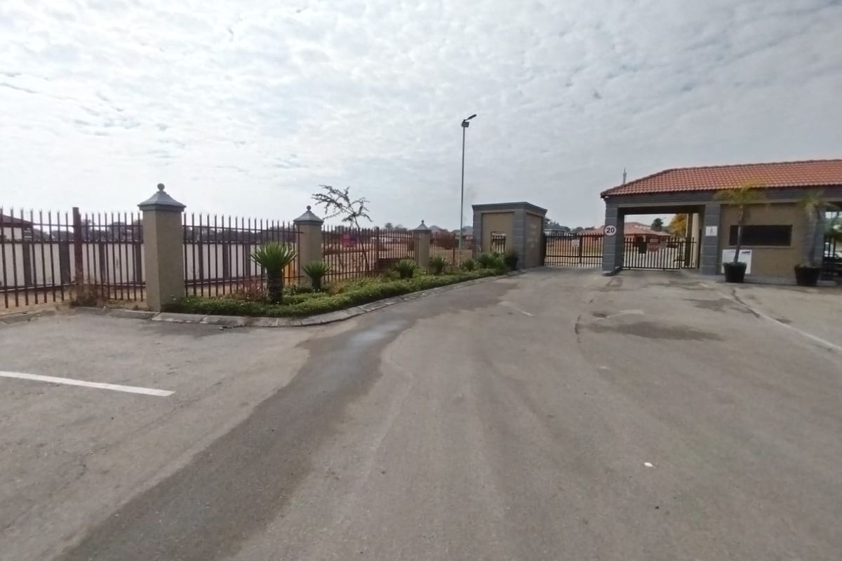 View of the secure gated entrance and perimeter fencing for the residential estate.