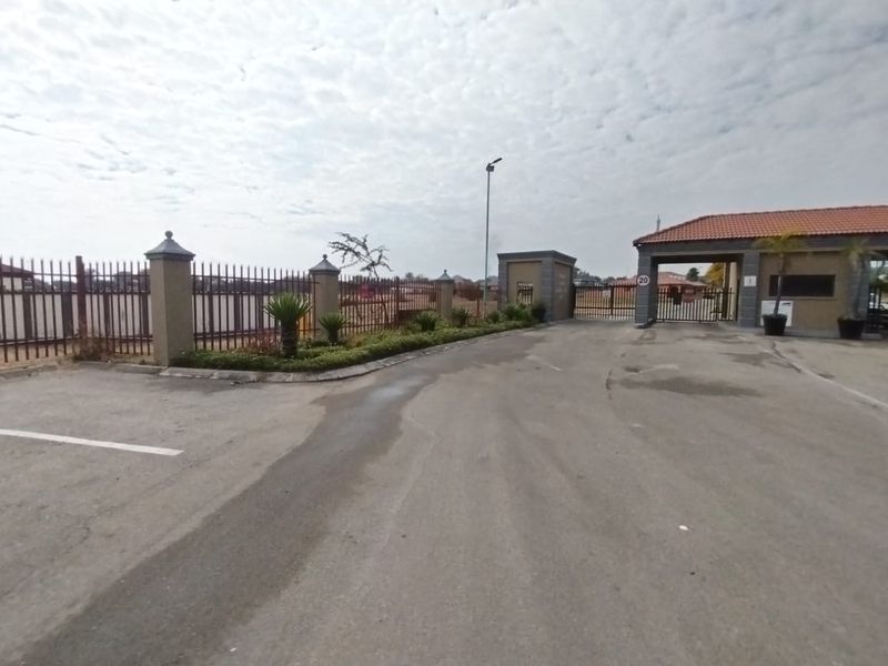 View of the secure gated entrance and perimeter fencing for the residential estate.