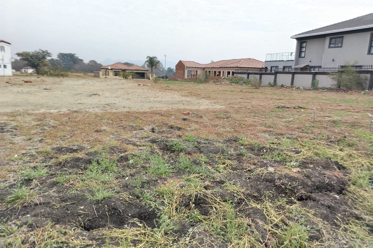 A vacant residential plot of land featuring open space, ready for development, situated within an established neighborhood setting.