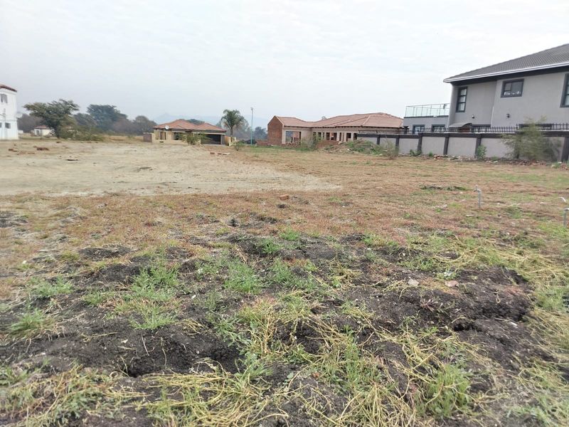 A vacant residential plot of land featuring open space, ready for development, situated within an established neighborhood setting.