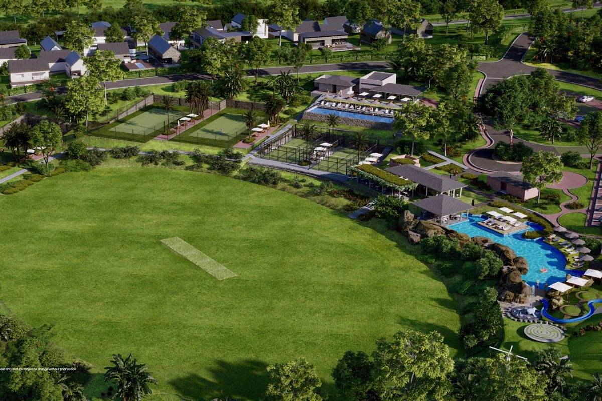 An aerial view of a residential estate featuring a cricket pitch, swimming pool, tennis courts, and clubhouse facilities.