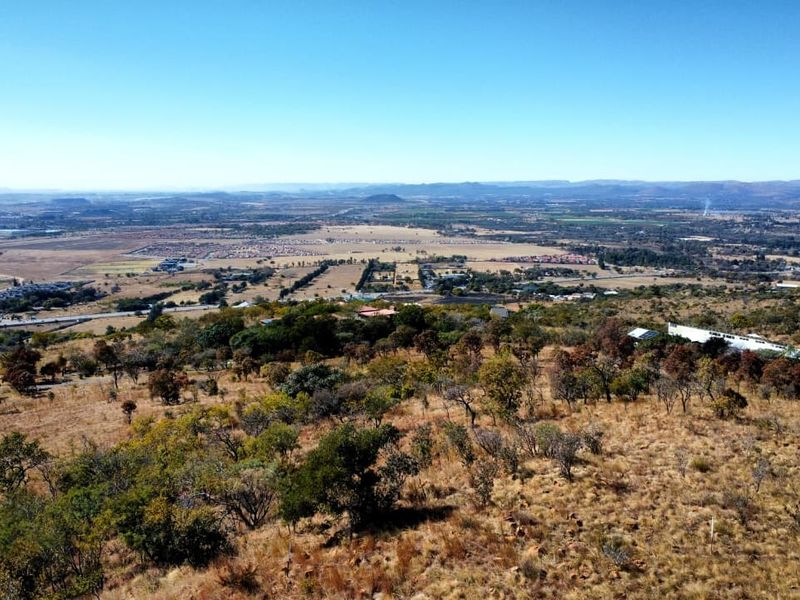 An elevated aerial view showcasing the expansive landscape and surrounding terrain of the vacant residential land.