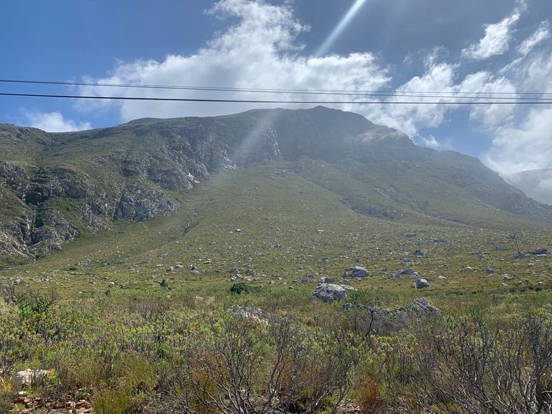 A scenic view of the natural mountain landscape, showcasing the rugged terrain and open space of the vacant residential land.