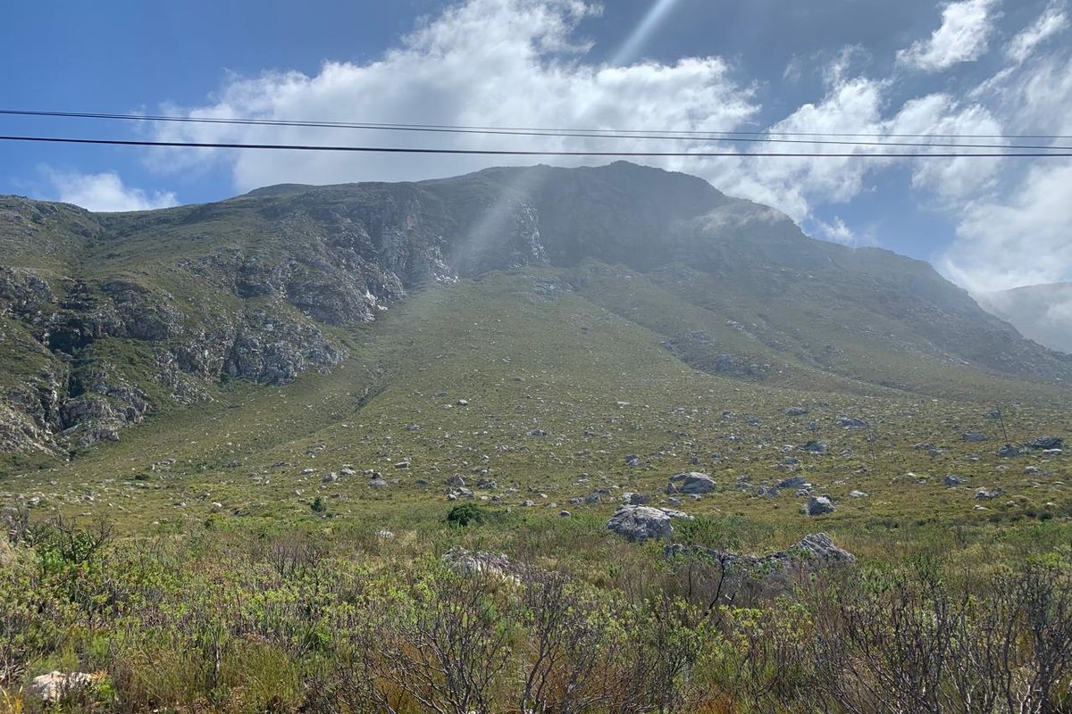 A scenic view of the natural mountain landscape, showcasing the rugged terrain and open space of the vacant residential land.