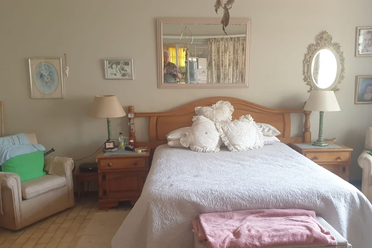 A bedroom featuring tiled flooring and neutral wall finishes, providing a functional space for rest.