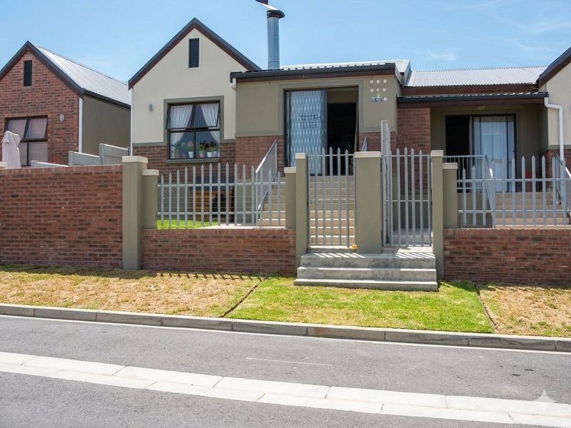 Front elevation of a duet property featuring a brick and plaster facade, steel palisade fencing, and a private entrance with concrete steps.