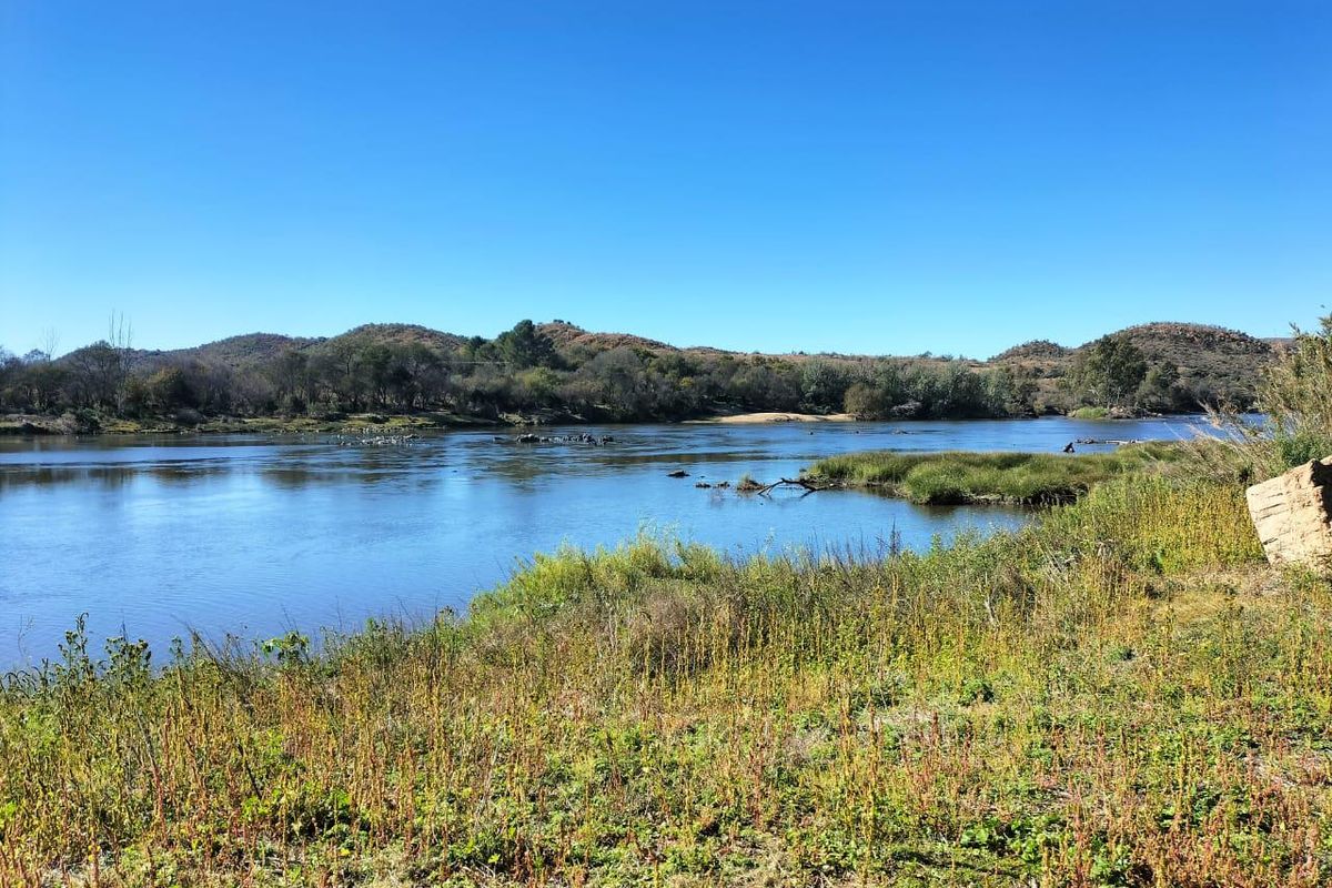 A scenic view of the river and surrounding natural landscape, showcasing the property's tranquil outdoor setting.
