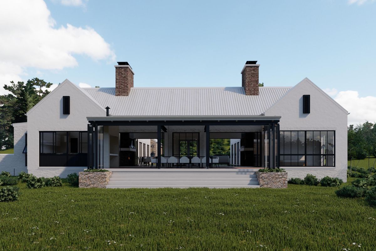 A rear view of a modern farmhouse-style home featuring a covered patio, brick chimneys, and large windows overlooking a landscaped garden.