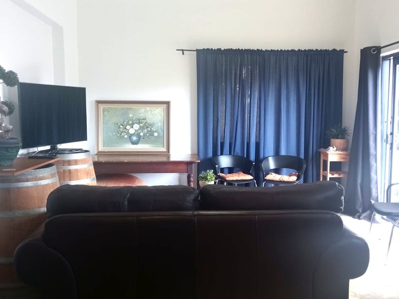 A living room area featuring a sliding glass door providing natural light and access to the exterior.