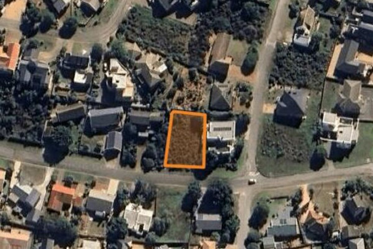 Aerial view of a vacant residential land plot situated within an established suburban neighborhood.