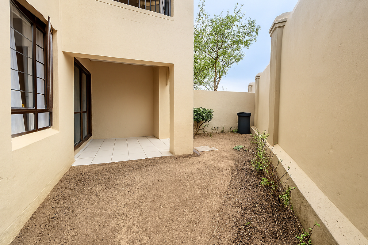 A private rear courtyard featuring a covered tiled patio area and an enclosed garden space with perimeter boundary walls.
