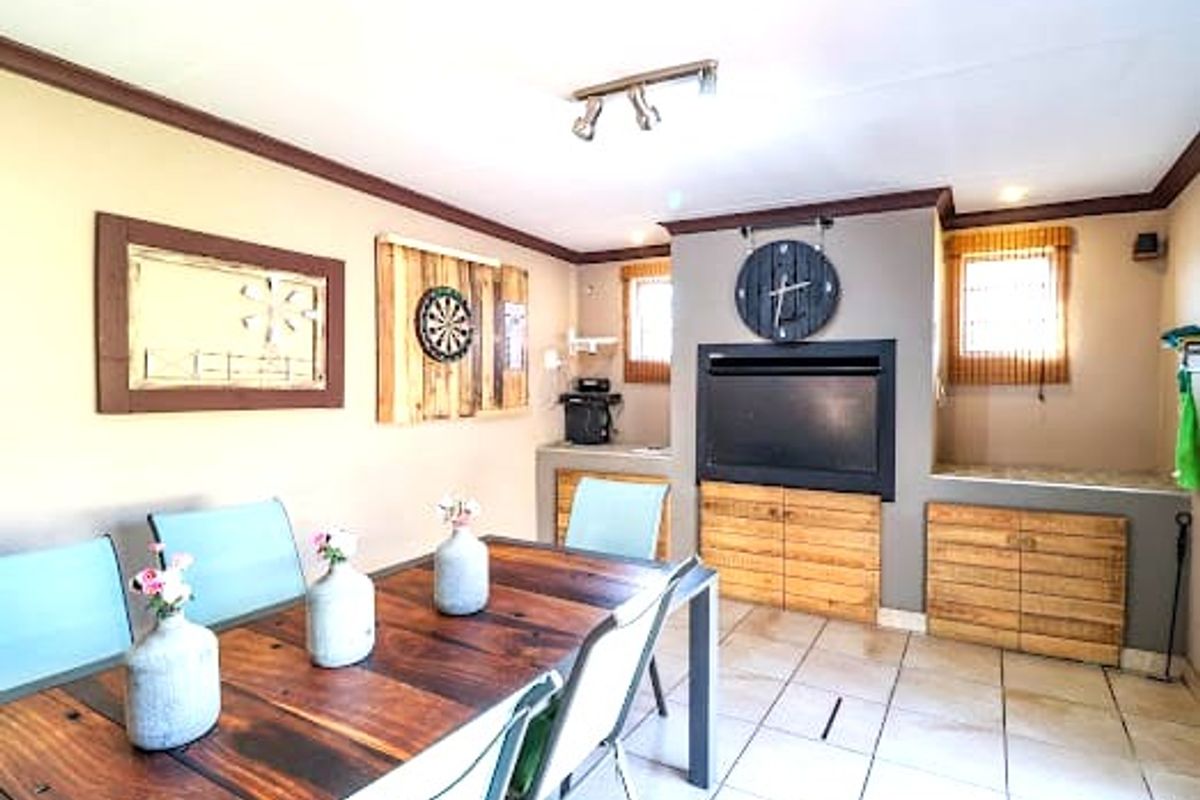 A living area featuring a built-in fireplace, custom cabinetry, and tiled flooring, providing a functional space for relaxation and entertainment.