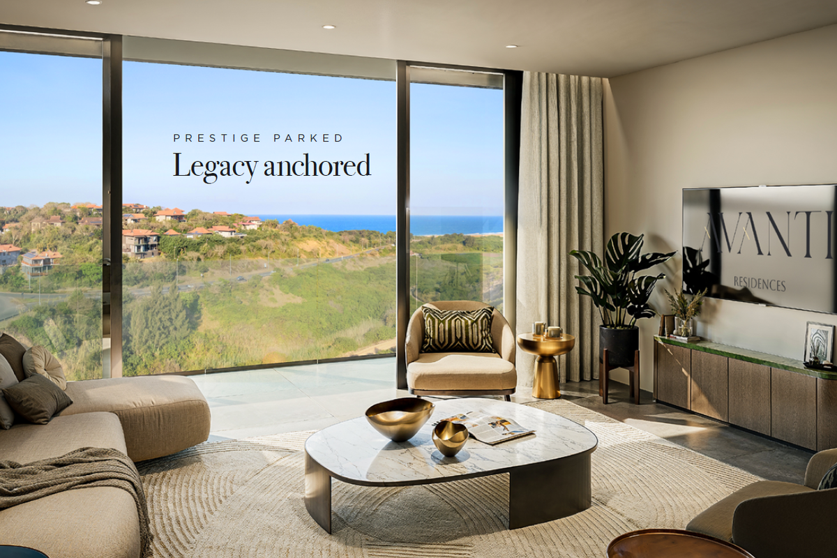 Modern living room featuring floor-to-ceiling windows with expansive coastal and landscape views, integrated lighting, and high-end finishes.
