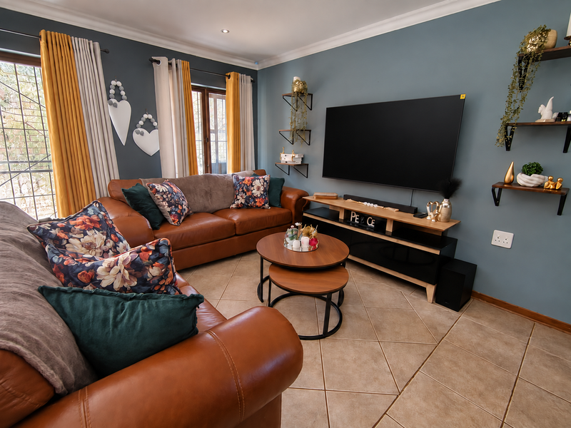 A well-maintained living room featuring tiled flooring, recessed lighting, and coved cornicing, creating a comfortable and inviting space for relaxation.